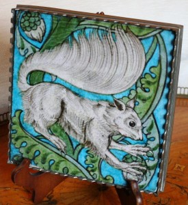 A William de Morgan tile black and white squirrel