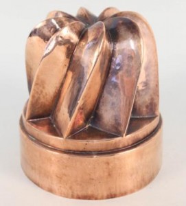 A large Victorian circular copper jelly mould having eight angled and swirled turrets