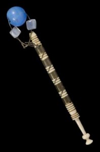 Bone or ivory bobbin with bead weights and bound with metal wire