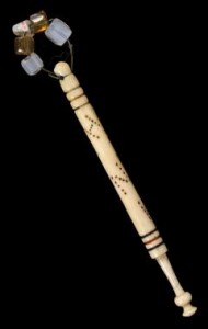 Bone or ivory bobbin with bead weights and punched with the name Hannah