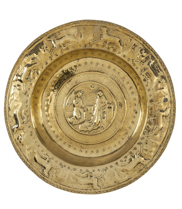 A large brass alms dish Nuremberg 16th century depicting The Annunciation