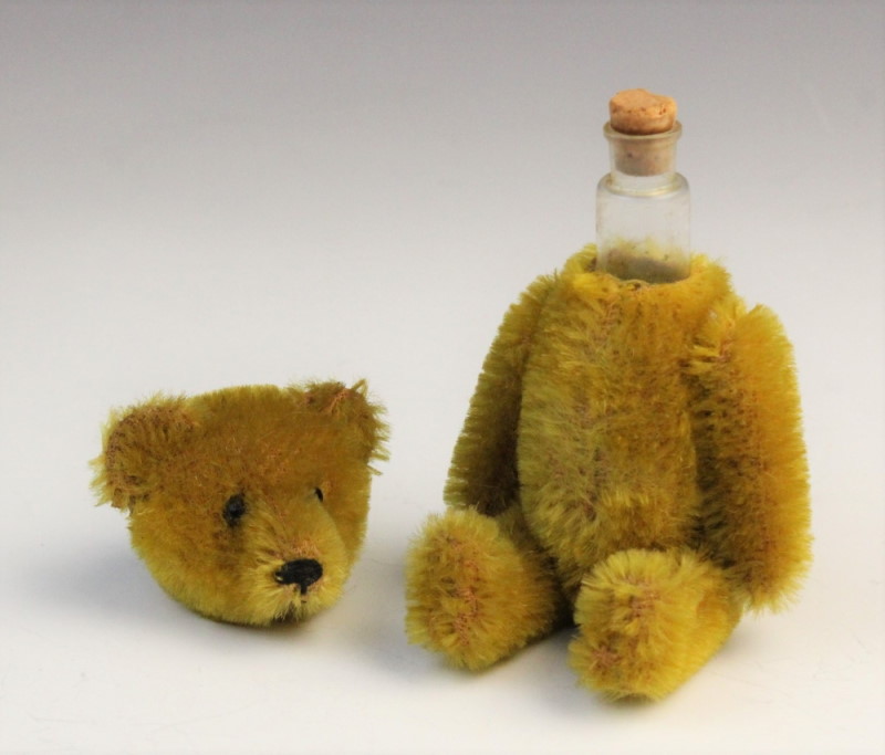 A Schuco perfume teddy bear showing glass liner and cork stopper