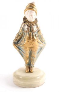 Georges Omerth a patinated bronze and ivory figure of a boy clown numbered 8446