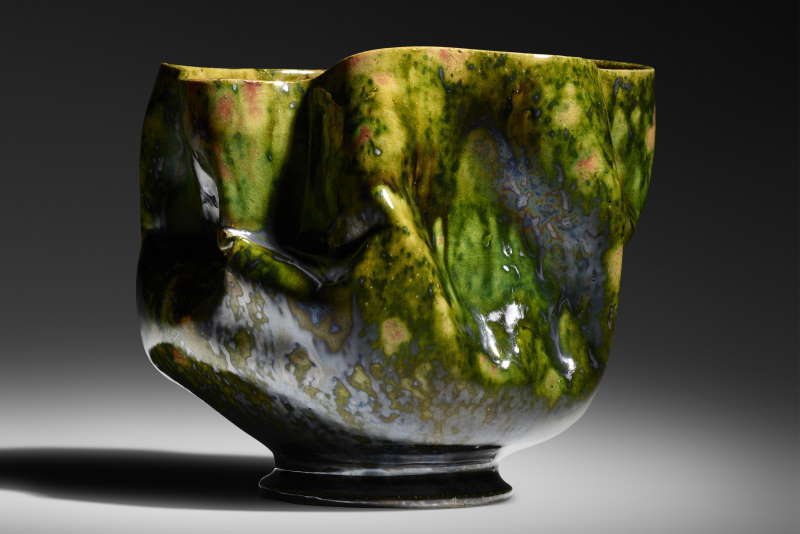 george ohr vase features in-body manipulations and green, gunmetal, and raspberry glazes with a yellow interior