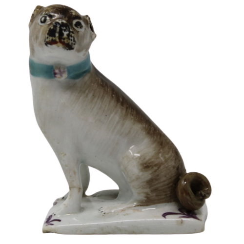 A rare Lowestoft porcelain sitting pug dog on a rectangular base