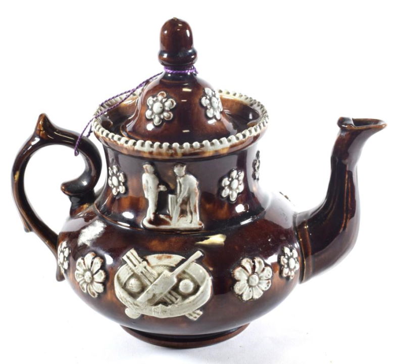A Measham Bargeware Teapot and Cover of Cricketing Interest,circa 1890 applied with cricketers bats and balls