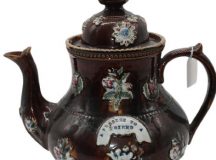 A Victorian bargeware teapot inscribed A present for a friend