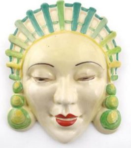 A Clarice Cliff Marlene wall mask with headdress in various greens