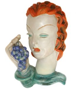 A Goldscheider pottery wall mask 7527 lady holding bunch of grapes