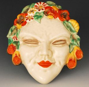 Clarice Cliff Flora wall mask with floral hair picked out in green brown red and green