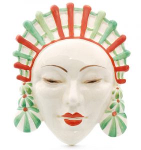 Clarice Cliff Marlene wall mask wearing an ornate headdress with earrings picked out in tonal green and red
