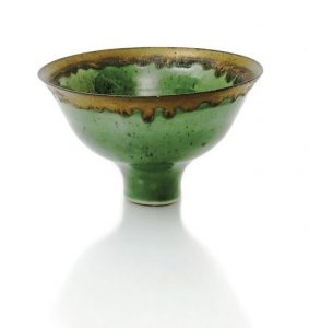 Dame Lucie Rie a fine porcelain footed bowl, covered in a translucent apple green glaze with manganese speckles