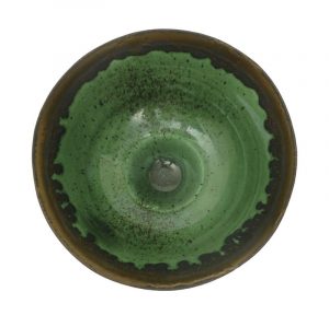 Dame Lucie Rie a fine porcelain footed bowl, covered in a translucent apple green glaze with manganese speckles