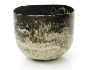 Lucie Rie an early earthenware vase circa 1936 elliptical form running cream and brown glaze with solid brown rim