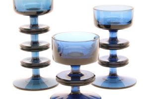 A set of three blue glass Sheringham candleholders