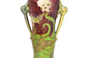 Zsolnay a Eosin glazed ceramic vase with twin elephant-head handles and stylised fish decoration c1905