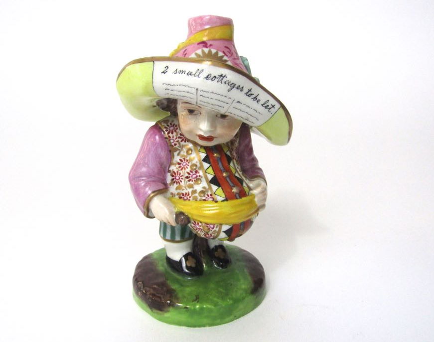 A 19th century figure of a Mansion House dwarf with large hat inscribed Two Small Cottages to be Let