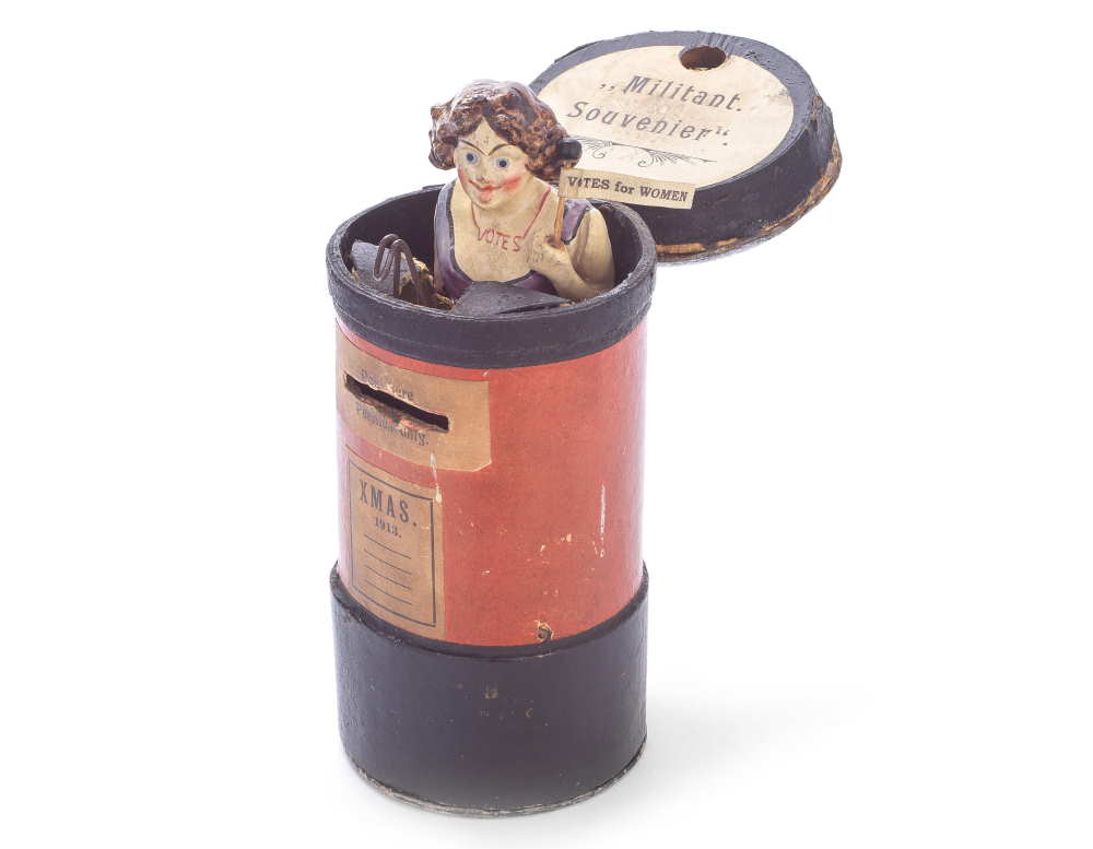 Rare Suffragette money box in the form of a pillar box containing a painted figure of a suffragette