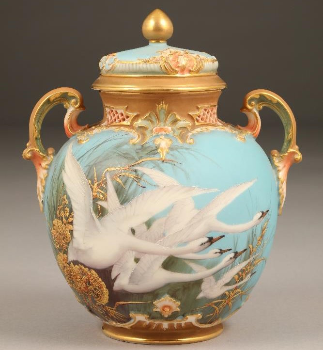 Fine Royal Worcester porcelain vase and cover by Charles Baldwyn baluster form with five swans in flight and grasses with raised gold foliage