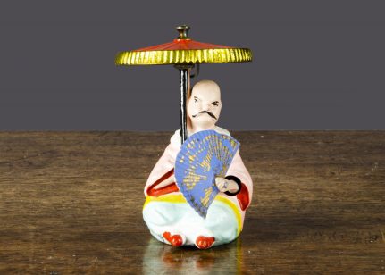A Britains The Mikado flywheel-driven toy from the 1880 catalogue complete with original paper fan
