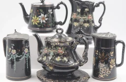 Collection of six decorated Jackfield Ware items including a teapot and stand