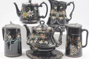 Collection of six decorated Jackfield Ware items including a teapot and stand