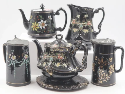Collection of six decorated Jackfield Ware items including a teapot and stand
