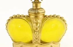 A Prince Matchabelli yellow moulded glass scent bottle modelled as a crown