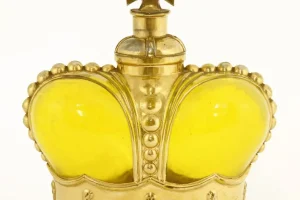 A Prince Matchabelli yellow moulded glass scent bottle modelled as a crown