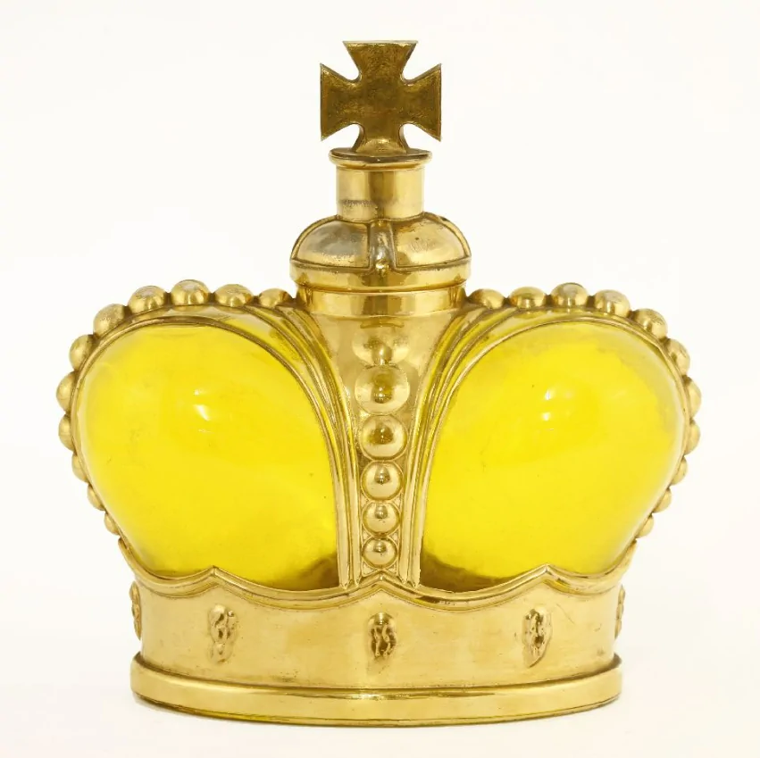 A Prince Matchabelli yellow moulded glass scent bottle modelled as a crown